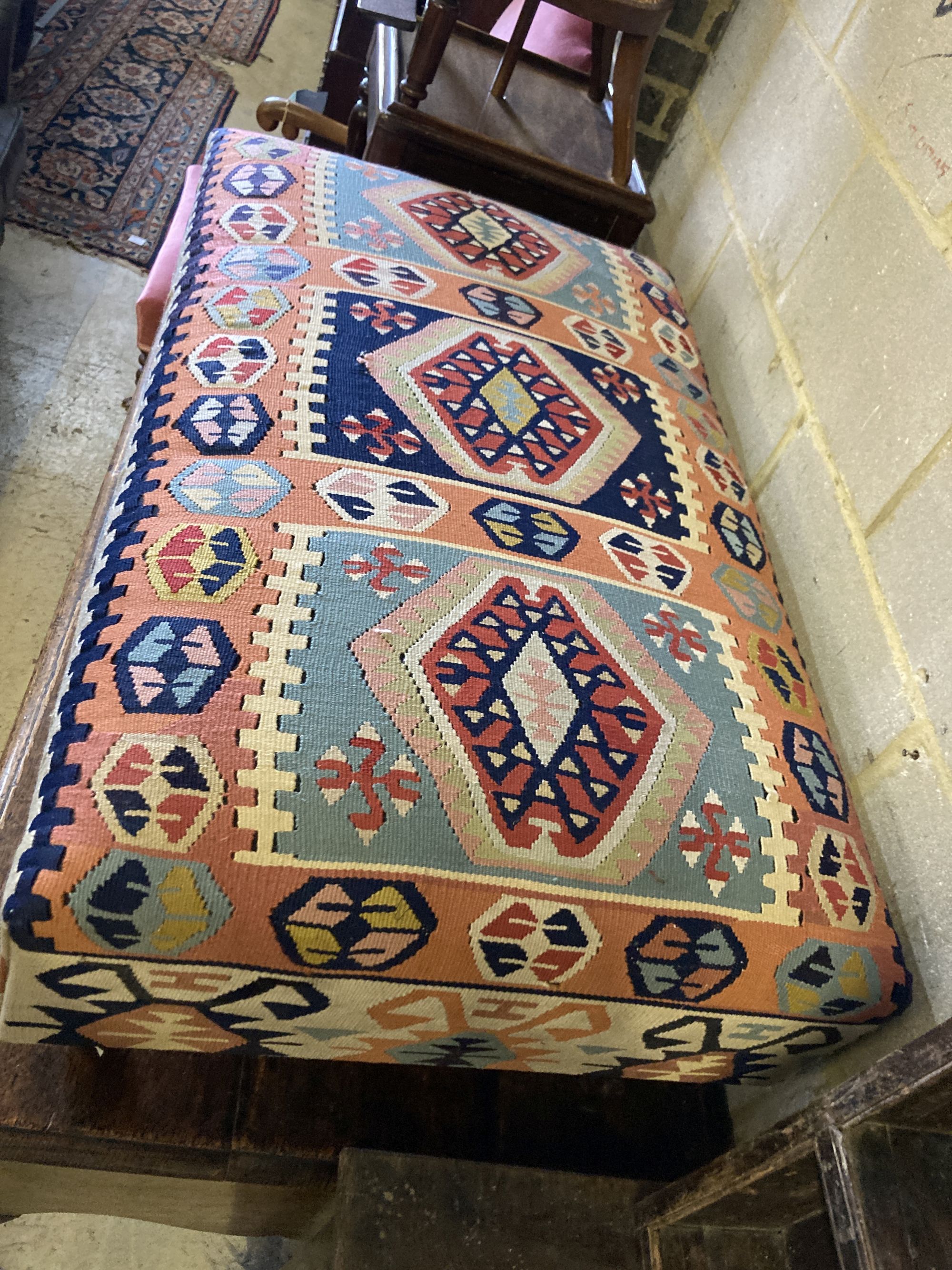 A Victorian style rectangular Kilim upholstered footstool, length 110cm, width 65cm, height 37cm
